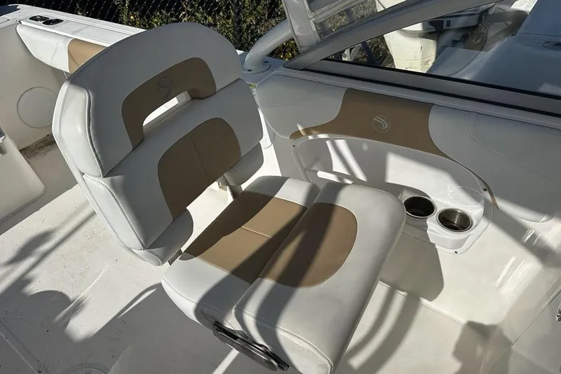 Slide: The Image of 2014 Edgewater 245CX Crossover boat interior with beige and white seating. - 9