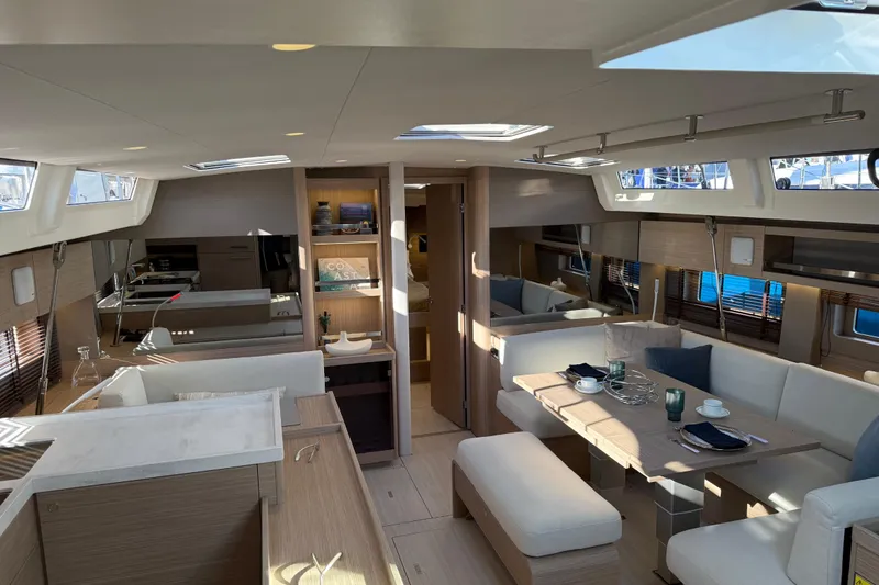 Slide: The Image of Luxurious interior of 2026 Beneteau Oceanis 52 yacht with modern dining and seating area. - 5