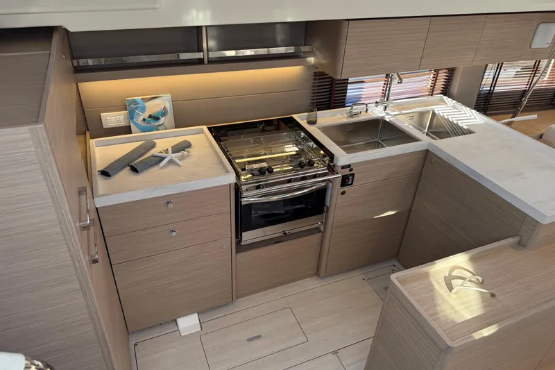 Slide: The Image of Modern kitchen interior of 2026 Beneteau Oceanis 52 yacht, featuring sleek cabinetry and appliances. - 7