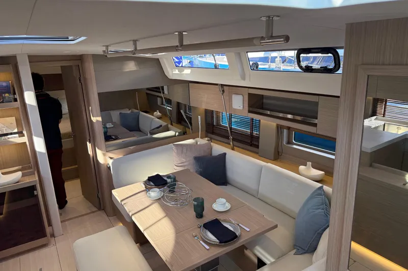 Slide: The Image of Luxurious interior of 2026 Beneteau Oceanis 52 yacht with modern dining area. - 8