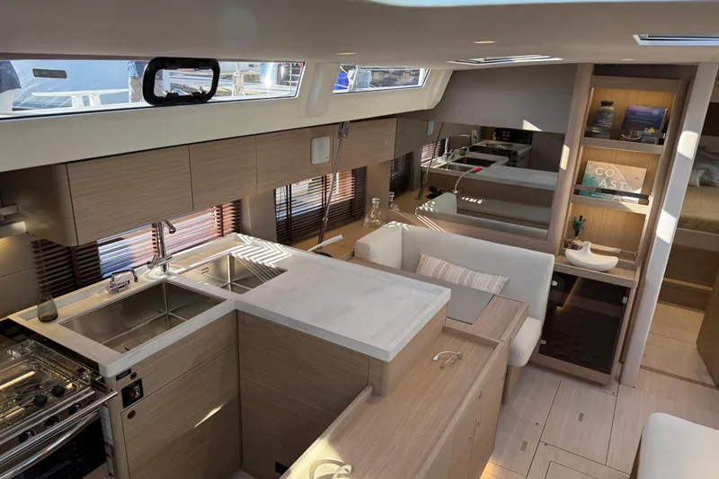 Slide: The Image of Luxurious interior of 2026 Beneteau Oceanis 52 yacht with modern kitchen and seating area. - 9