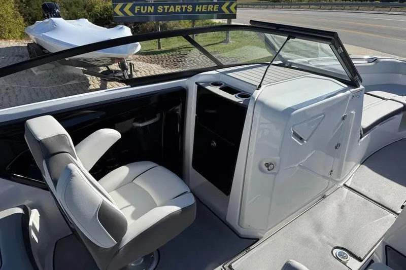 Slide: The Image of 2026 Yamaha Boats AR250 interior with captain's chair and dashboard, showcasing sleek design. - 10