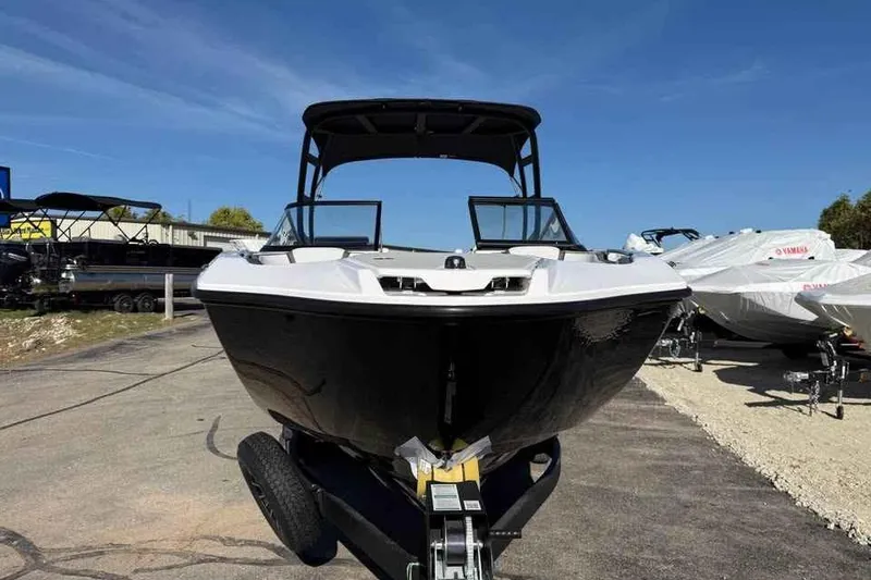 Slide: The Image of 2026 Yamaha Boats AR250 on trailer, sleek design under clear blue sky. - 2