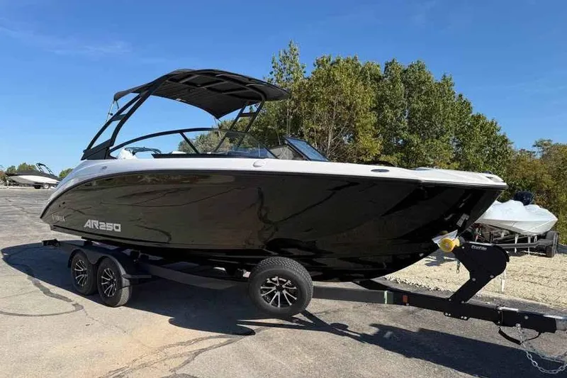 Slide: The Image of 2026 Yamaha Boats AR250 on trailer, sleek black design, parked outdoors. - 3