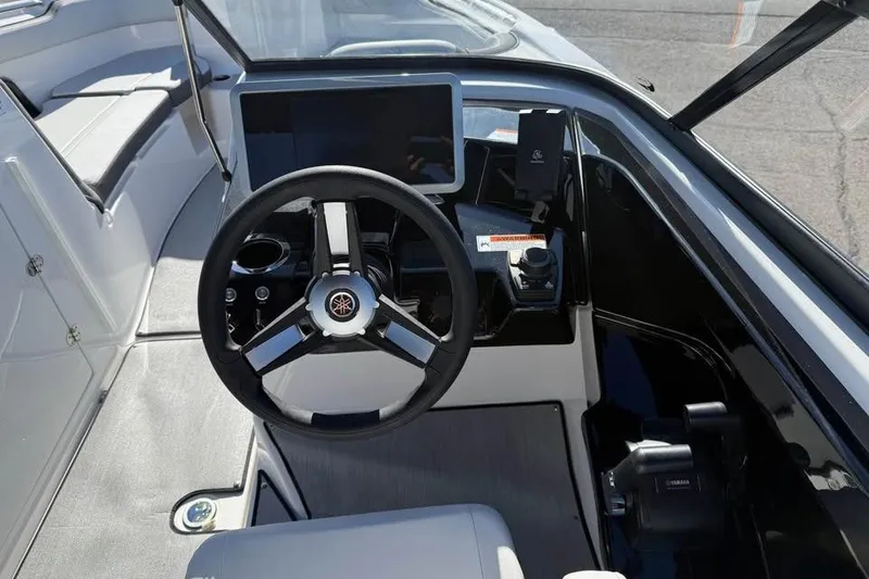 Slide: The Image of 2026 Yamaha Boats AR250 cockpit with steering wheel and modern dashboard controls. - 9