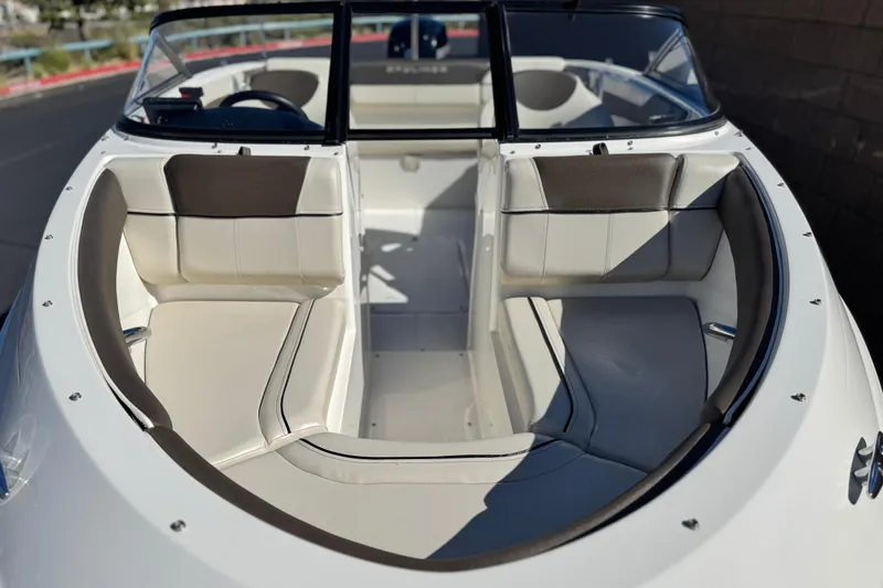Slide: The Image of 2019 Bayliner 180 Bowrider boat interior with white and gray seating. - 10