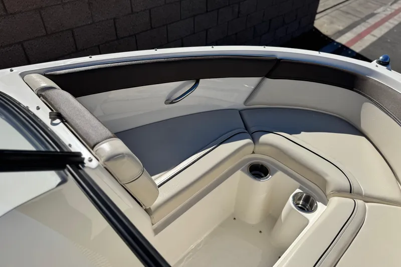 Slide: The Image of 2019 Bayliner 180 Bowrider interior with cushioned seating and cup holders. - 12