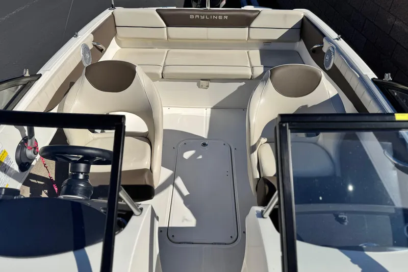 Slide: The Image of 2019 Bayliner 180 Bowrider interior with seating and steering wheel, showcasing modern design. - 14