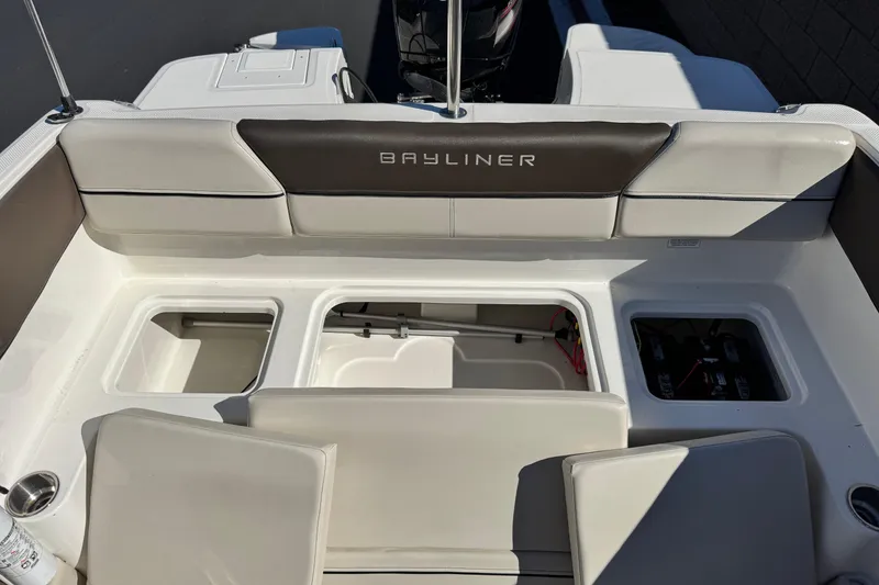 Slide: The Image of 2019 Bayliner 180 Bowrider interior with storage compartments and seating. - 16
