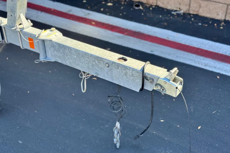 Slide: The Image of Trailer hitch for 2019 Bayliner 180 Bowrider on asphalt surface. - 24