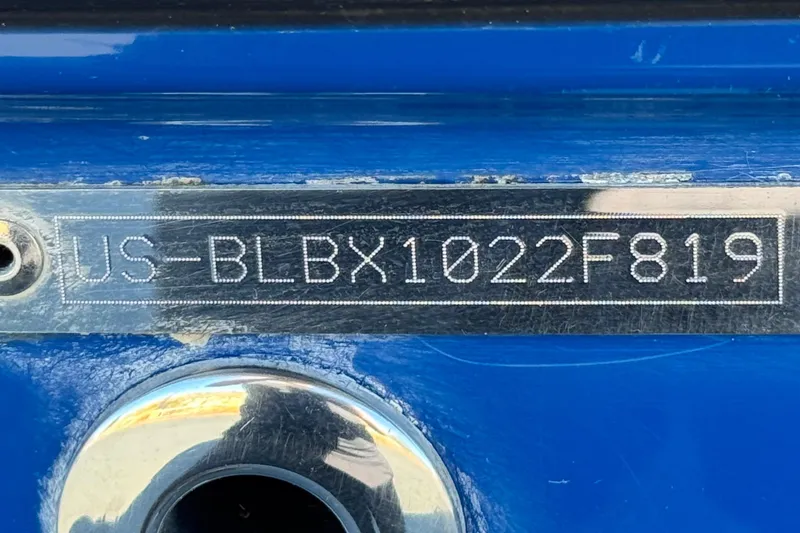 Slide: The Image of 2019 Bayliner 180 Bowrider hull identification number on blue surface. - 26