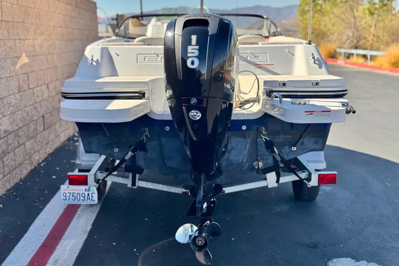 Slide: The Image of 2019 Bayliner 180 Bowrider with 150 HP outboard motor on trailer. - 4
