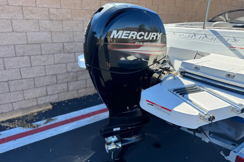 Slide: The Image of 2019 Bayliner 180 Bowrider with Mercury FourStroke outboard motor, parked near a brick wall. - 6