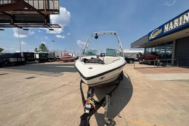 Slide: The Image of 2007 Centurion Air Warrior T5 boat on trailer at marina under clear sky. - 25