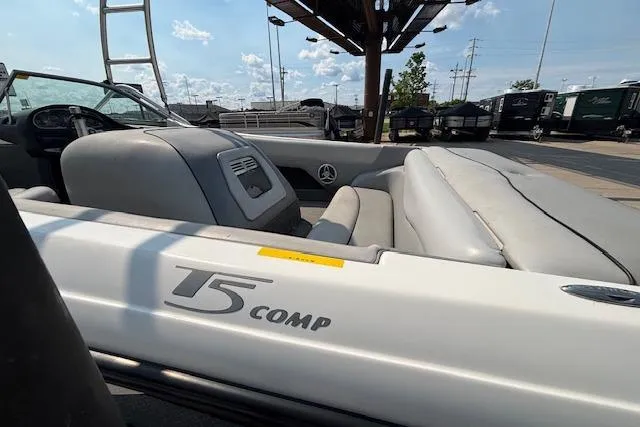 Slide: The Image of 2007 Centurion Air Warrior T5 boat interior with seating and dashboard, parked outdoors. - 28