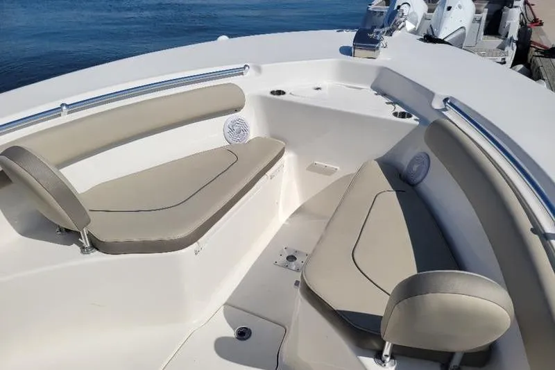 Slide: The Image of 2023 Key West 244 Center Console boat interior with beige seating and ocean backdrop. - 10