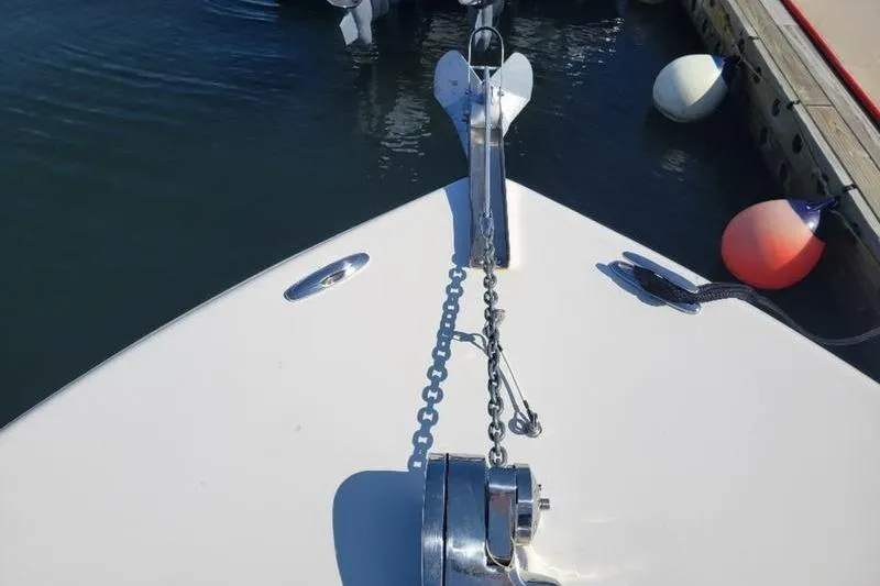 Slide: The Image of 2023 Key West 244 Center Console boat bow with anchor and chain in marina. - 11