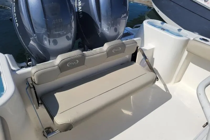 Slide: The Image of 2023 Key West 244 Center Console boat with dual Yamaha engines and cushioned seating. - 8