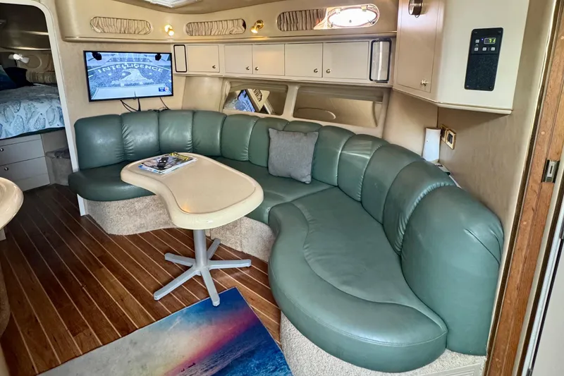 Slide: The Image of Luxurious interior of 1998 Sea Ray 400 Sundancer yacht with green leather seating. - 10