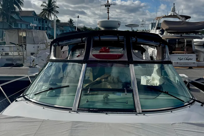 Slide: The Image of 1998 Sea Ray 400 Sundancer yacht docked at marina with palm trees in background. - 4