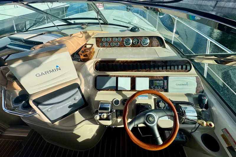 Slide: The Image of Cockpit of 1998 Sea Ray 400 Sundancer with Garmin navigation system and wooden steering wheel. - 8