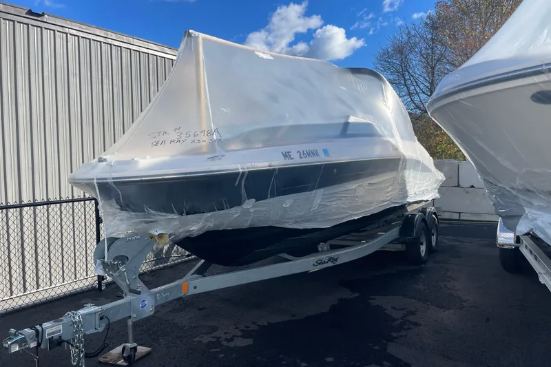 Slide: The Image of 2024 Sea Ray 230 Sportster Bow Rider wrapped on trailer, outdoor storage. - 11