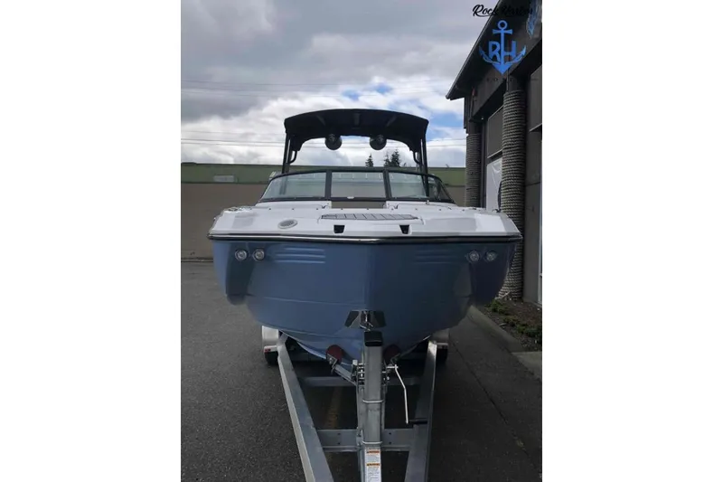 Slide: The Image of 2022 Monterey M6 boat on trailer, front view under cloudy sky. - 2