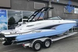 Slide: The Image of 2022 Monterey M6 boat on trailer, sleek design, white and blue exterior. - 3