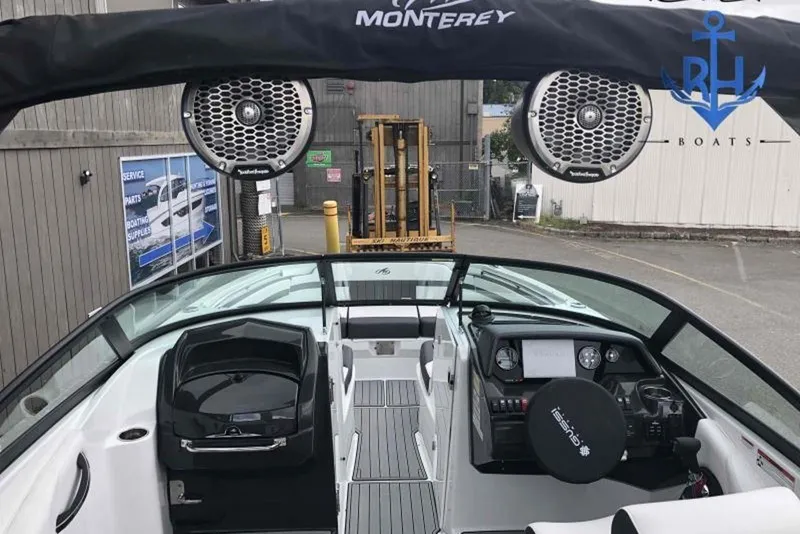 Slide: The Image of 2022 Monterey M6 boat interior with speakers and control panel, docked at marina. - 7