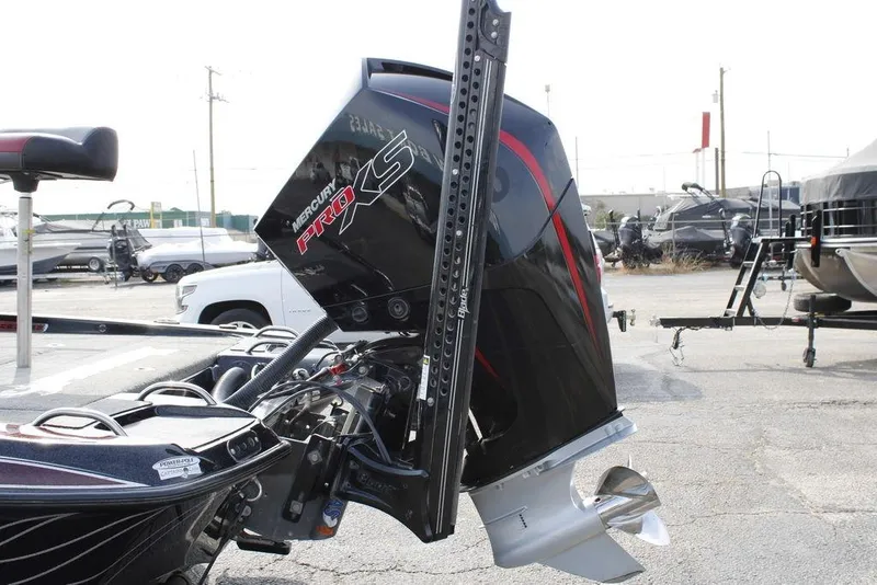 Slide: The Image of 2021 Phoenix 21 PHX boat with Mercury Pro XS outboard motor in a parking lot. - 11