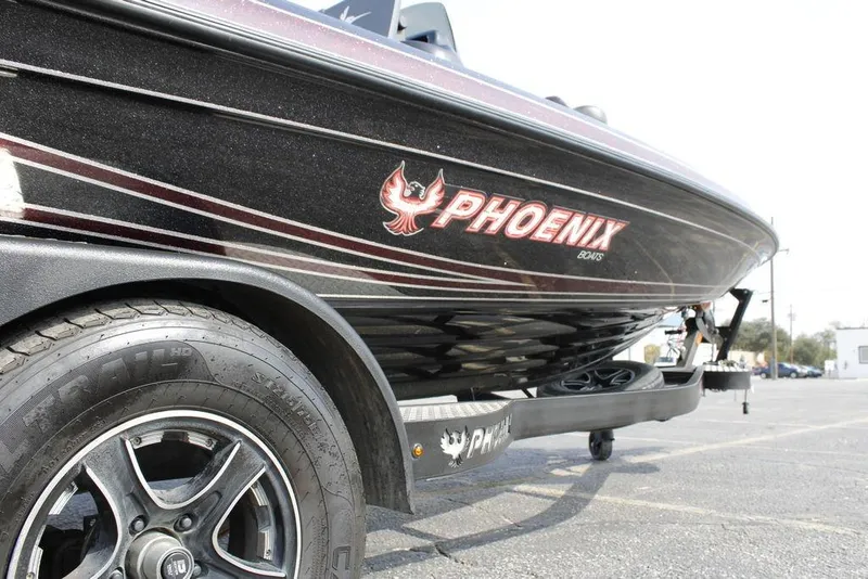 Slide: The Image of 2021 Phoenix 21 PHX boat on trailer, showcasing sleek design and branding. - 18