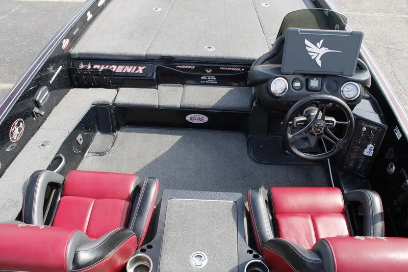 Slide: The Image of 2021 Phoenix 21 PHX boat interior with red seats and modern dashboard. - 24