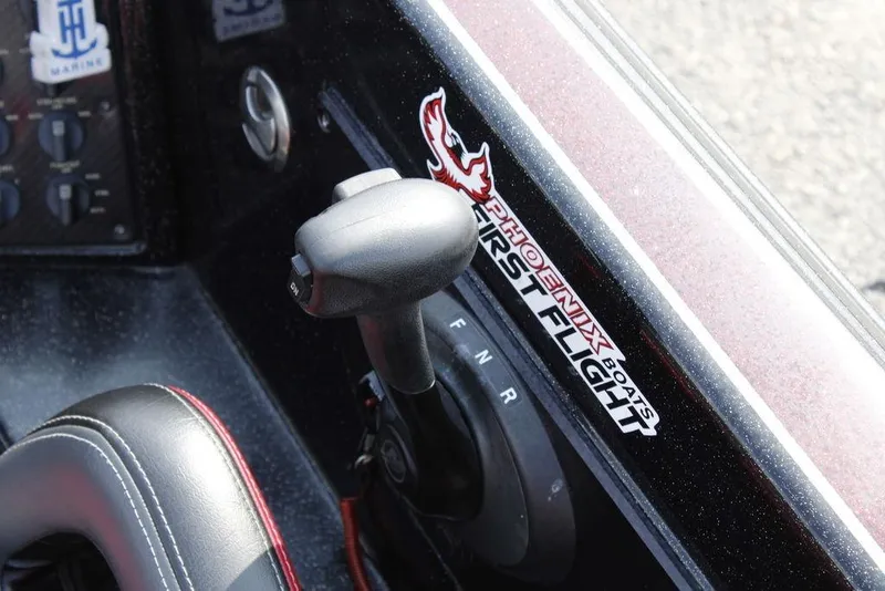 Slide: The Image of 2021 Phoenix 21 PHX boat control panel with gear shift and branding. - 29