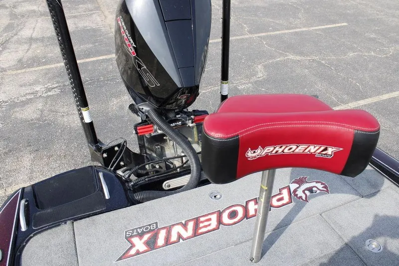 Slide: The Image of 2021 Phoenix 21 PHX boat with red seat and motor, parked on asphalt. - 31