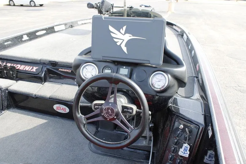 Slide: The Image of 2021 Phoenix 21 PHX boat dashboard with steering wheel and gauges. - 33
