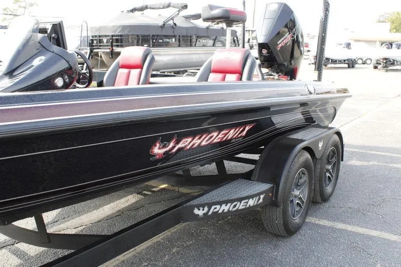 Slide: The Image of 2021 Phoenix 21 PHX boat on trailer, featuring sleek design and red-accented seats. - 7