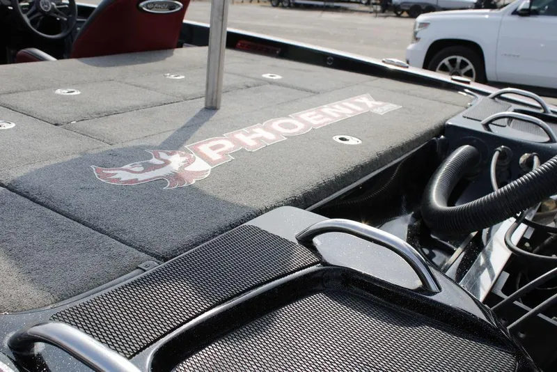 Slide: The Image of 2021 Phoenix 21 PHX boat deck with logo, featuring storage compartments and seating. - 9