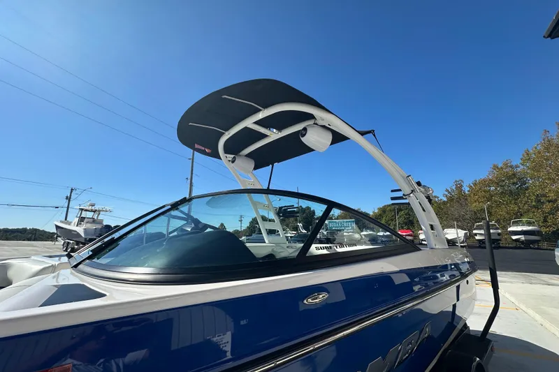 Slide: The Image of 2015 Moomba Mobius LSV boat with blue exterior and embossed branding. - 12