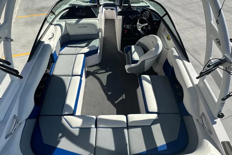 Slide: The Image of 2015 Moomba Mobius LSV boat near a dealership, showcasing wakeboard rack and tower. - 19