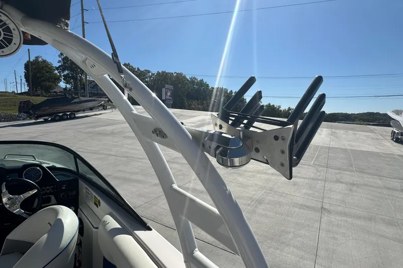 Slide: The Image of 2015 Moomba Mobius LSV boat with tower speakers and sunshade, parked outdoors. - 20