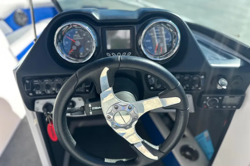 Slide: The Image of 2015 Moomba Mobius LSV boat interior with gray and blue seating arrangement. - 27