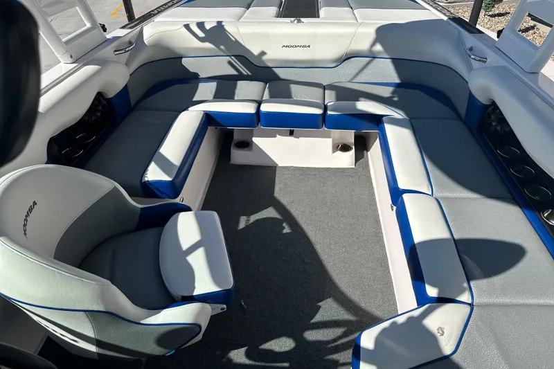 Slide: The Image of 2015 Moomba Mobius LSV boat interior with speakers, parked near other boats and vehicles. - 29