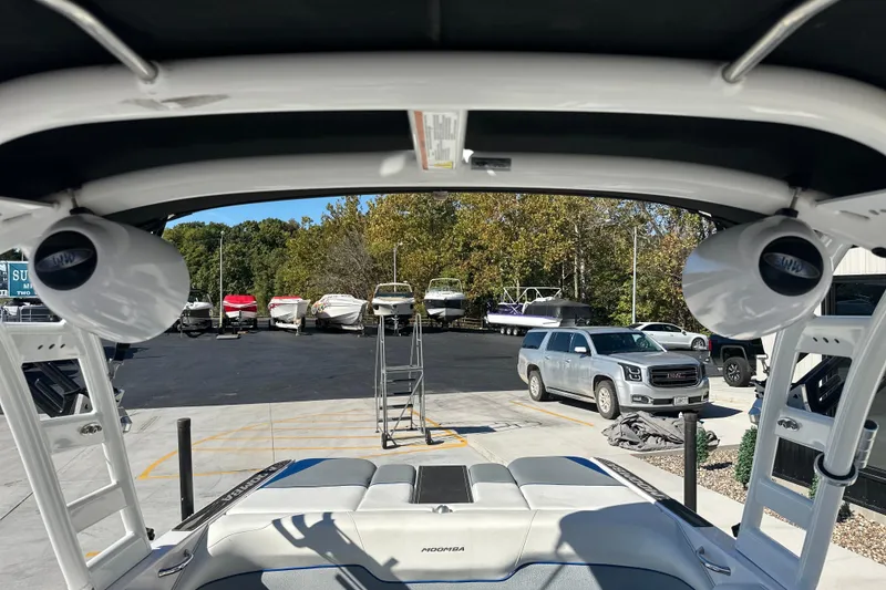 Slide: The Image of 2015 Moomba Mobius LSV boat interior with white upholstery and metal fixture. - 31