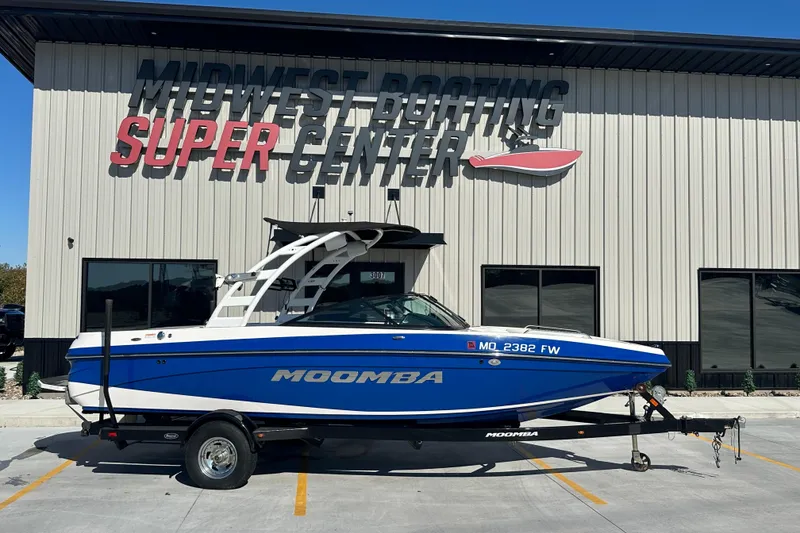 Slide: The Image of 2015 Moomba Mobius LSV boat parked outside a dealership on a sunny day. - 4