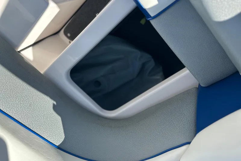 Slide: The Image of 2015 Moomba Mobius LSV boat engine compartment with open hatches in a parking area. - 40