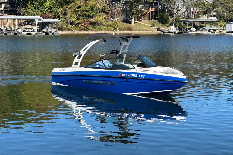 Slide: The Image of 2015 Moomba Mobius LSV boat on a calm lake with scenic background. - 53