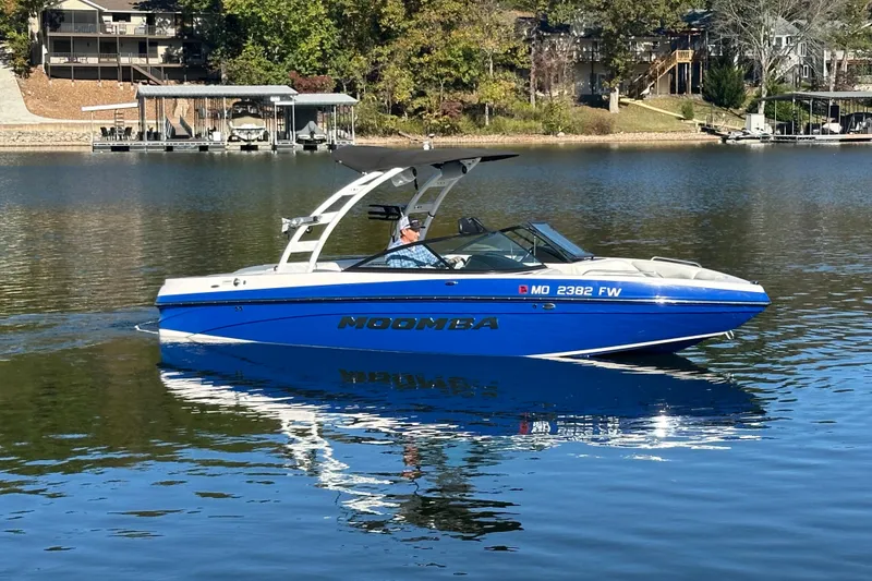 Slide: The Image of 2015 Moomba Mobius LSV boat cruising on a calm lake. - 56