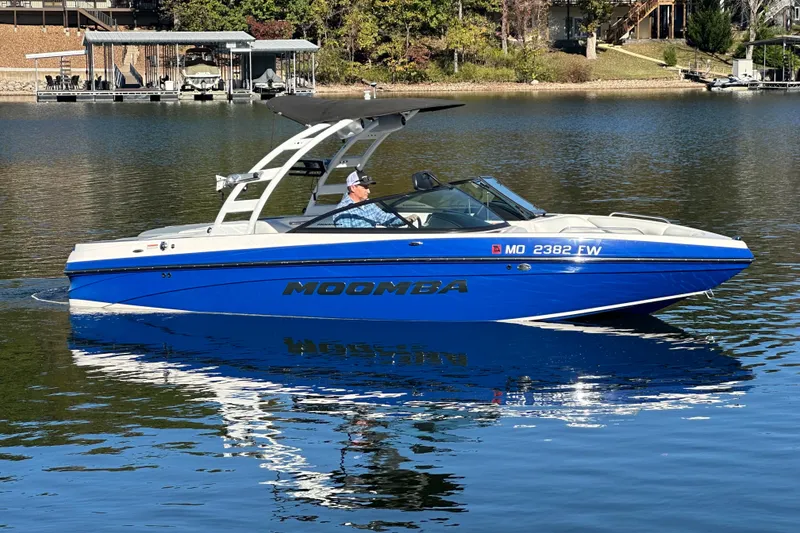 Slide: The Image of 2015 Moomba Mobius LSV boat cruising on a calm lake. - 57