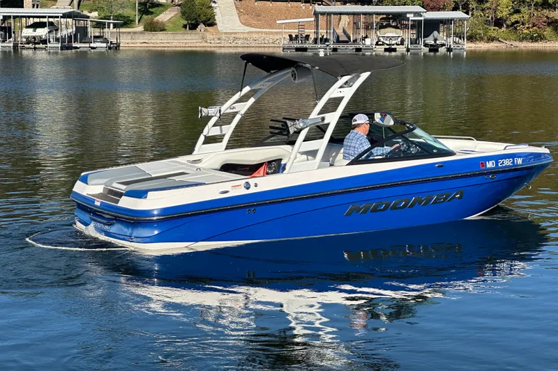 Slide: The Image of 2015 Moomba Mobius LSV boat on calm water, rear view with driver. - 60