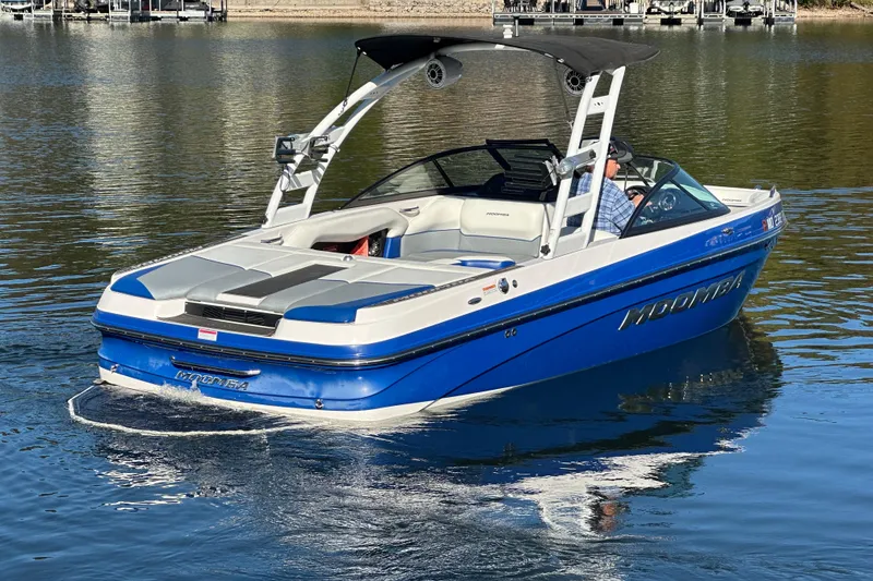 Slide: The Image of 2015 Moomba Mobius LSV boat cruising on a calm lake. - 61